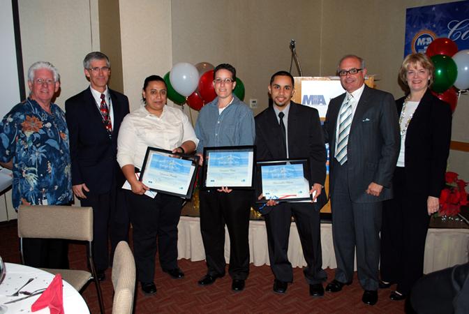 Employees of the Year Award winners Yomara Pineda, Veronica Ruiz and Christopher Maria (center) receive their awards from: Greater Miami Convention and Visitors Bureau President and CEO Bill Talbert; TSA Assistant Federal Security Director Rob Mclaughlin; Aviation Director José Abreu; and MDAD Terminal Operations and Customer Service Division Director Dickie Davis.